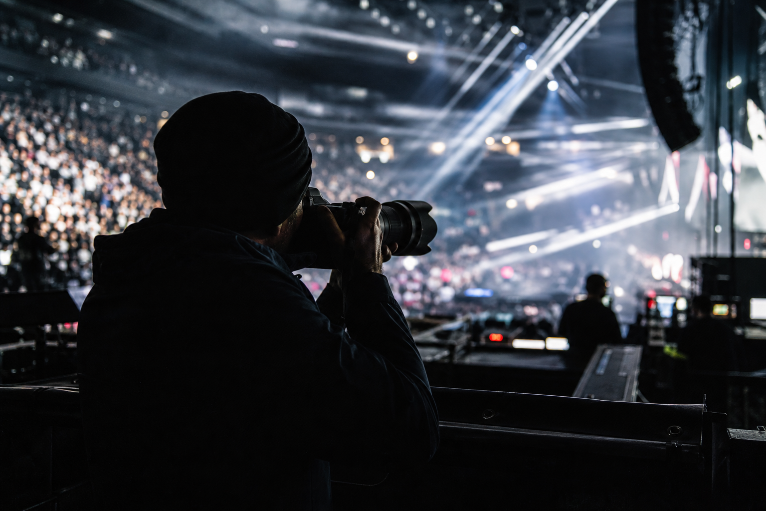 Media operator beside a live arena floor.