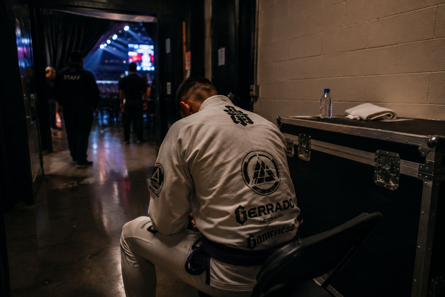 Athlete seated backstage before competition.